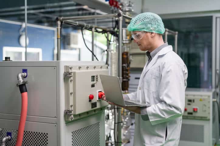 A cannabis extraction technician handling the extraction process after their cannabis industry training