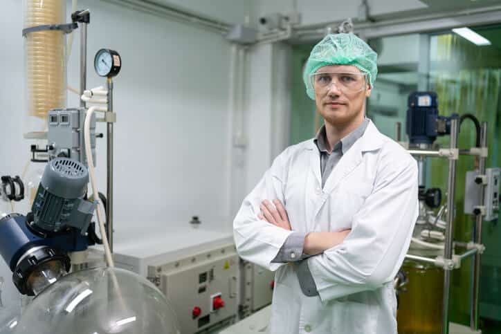 A cannabis extraction technician standing in a laboratory after cannabis industry training