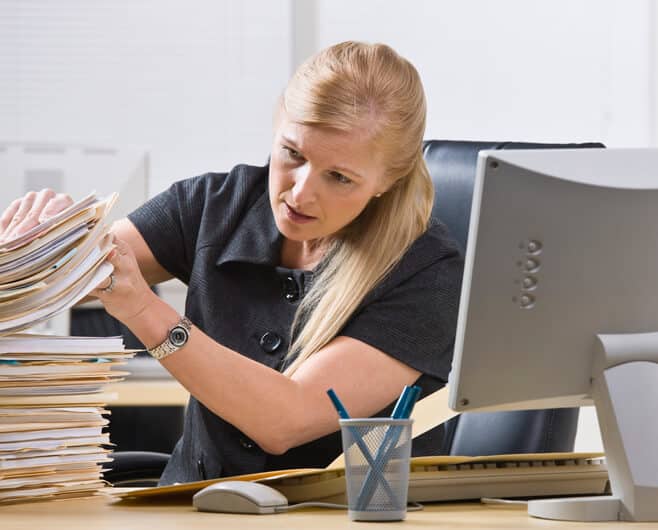 A female document controller sorting through documents after regulatory affairs training