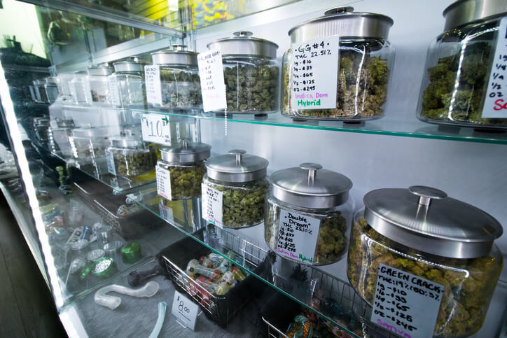 Labelled cannabis products placed on a shelf by a cannabis retail store owner after their cannabis industry training