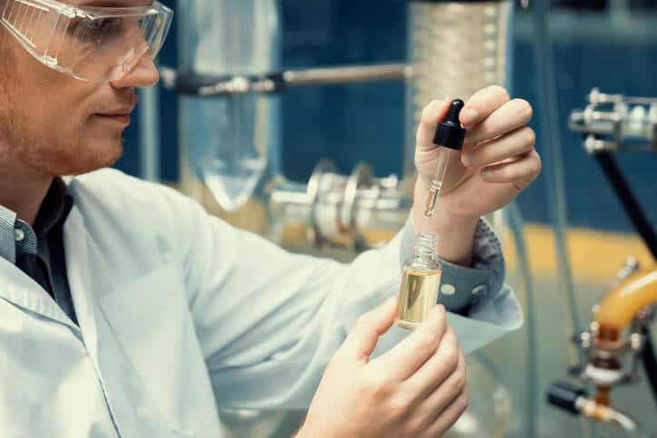 A cannabis professional extracting CBD oil in a laboratory after completing his cannabis industry training