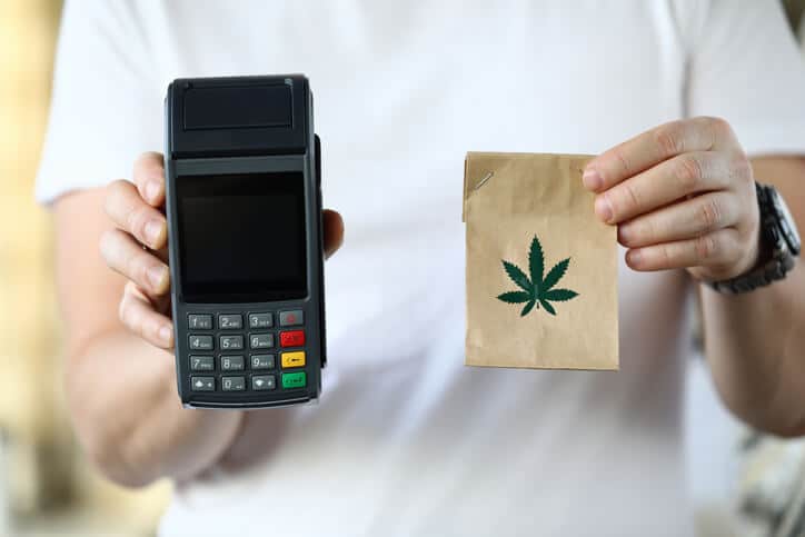 A cannabis industry specialist selling cannabis products to a female customer after cannabis industry training