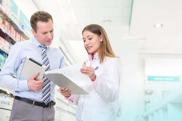 A pair of clinical research professionals reviewing a project charter document