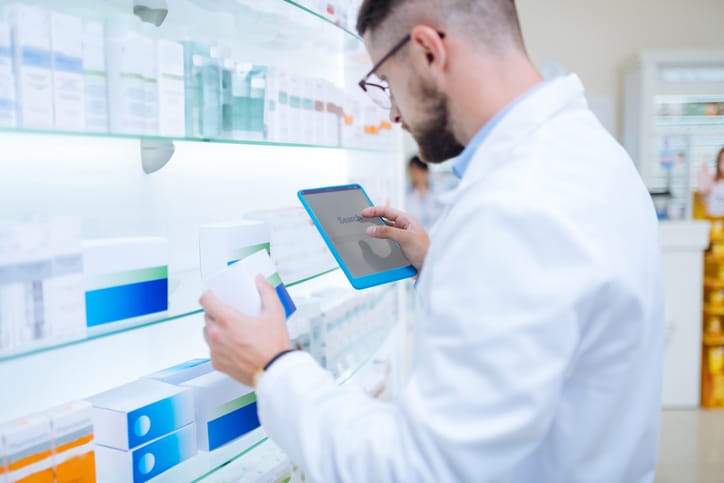 Male QA professional verifying information about drugs after completing his clinical research training