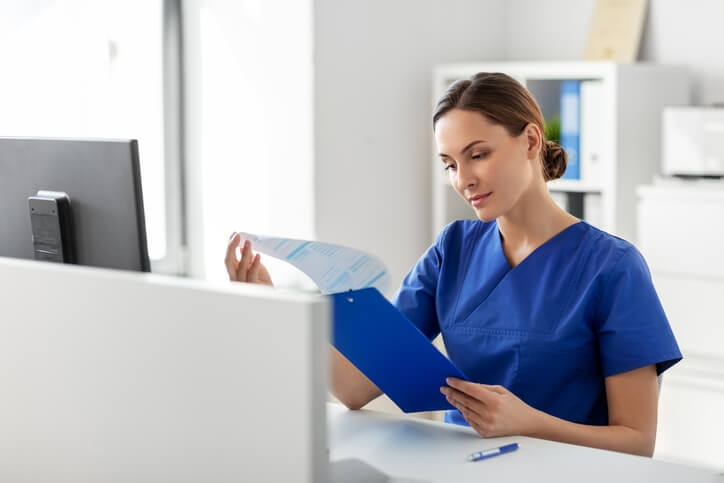 A medical information associate reviewing documents in a clinical research setting.