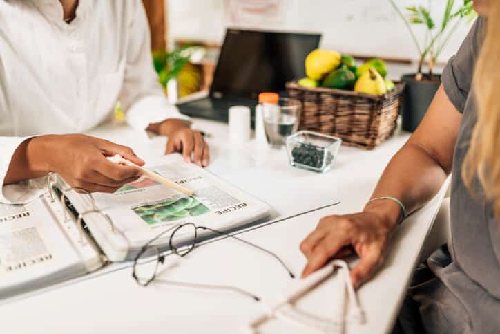 A female dietary consultant interacting with a client after completing her nutrition courses