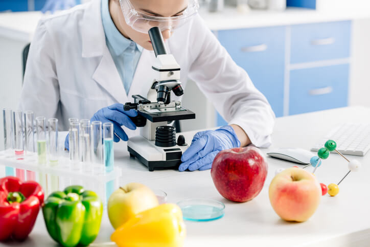 A microbiologist technician monitoring food quality in a laboratory after completing his food safety training