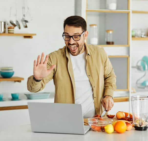 A male nutrition consultant in an online meeting with colleagues after completing his Diploma in Nutrition