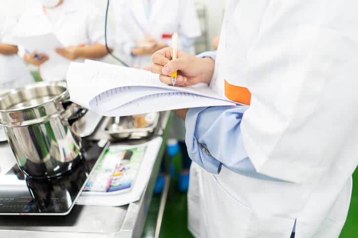 A public health inspector carrying out food safety checks at a restaurant