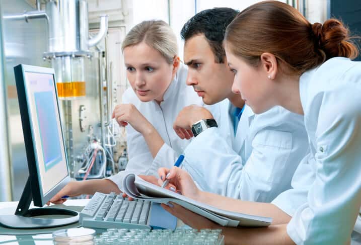 Pharma QA professionals taking a training course in a laboratory