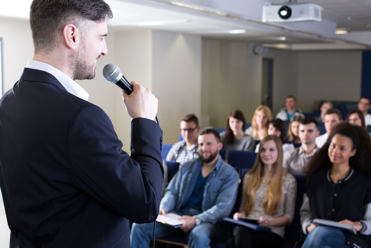 A panelist speaking to a group of students, providing insights into pharma career pathways.