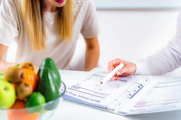 A female nutrition consultant interacting with a female client after completing her Diploma in Nutrition