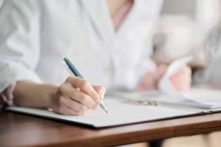 A female technical writer documenting clinical trials in a laboratory after pharmaceutical training