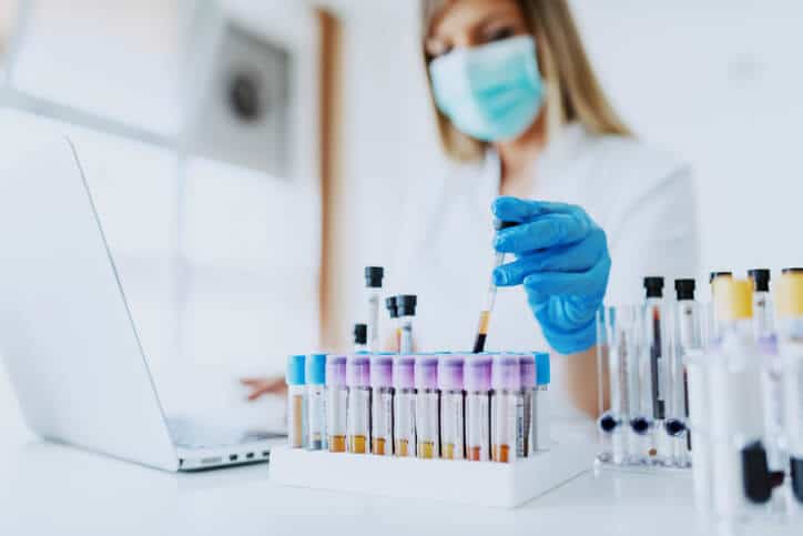 A clinical research training student working in a lab