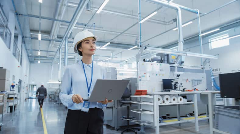 A female quality assurance Associate inspecting a manufacturing factory after her quality assurance training