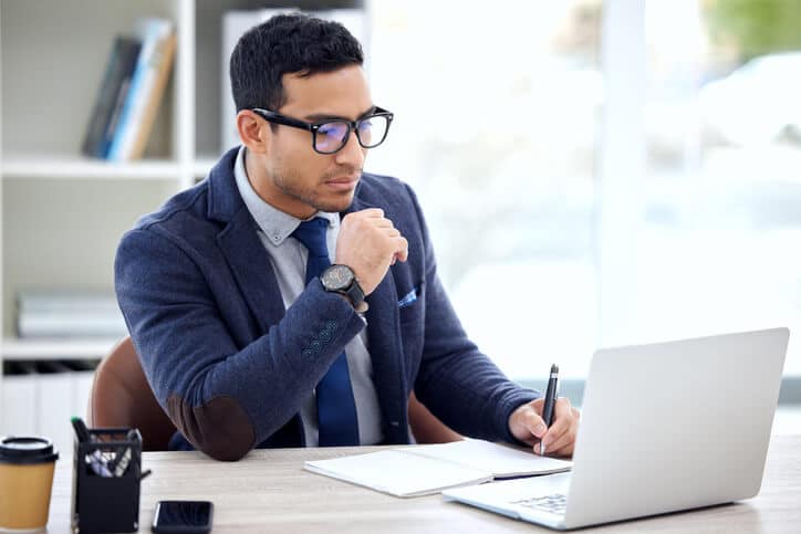 A male technical writer working on his portfolio after quality assurance training