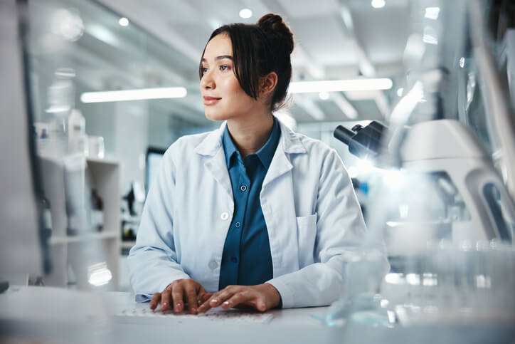 A female pharmaceutical QA professional at a manufacturing facility