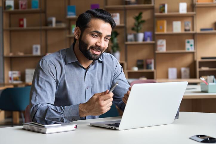 A smiling male pharmaceutical professional taking pharma courses online from home 